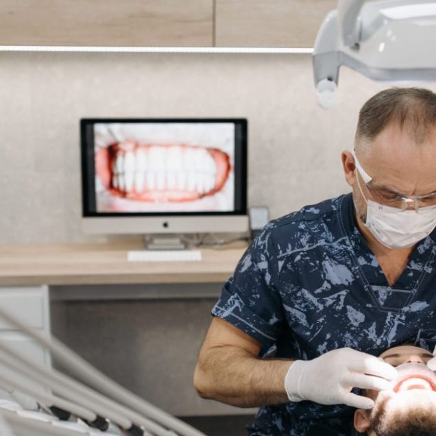 A dental professional reviewing information on a screen at a dental office